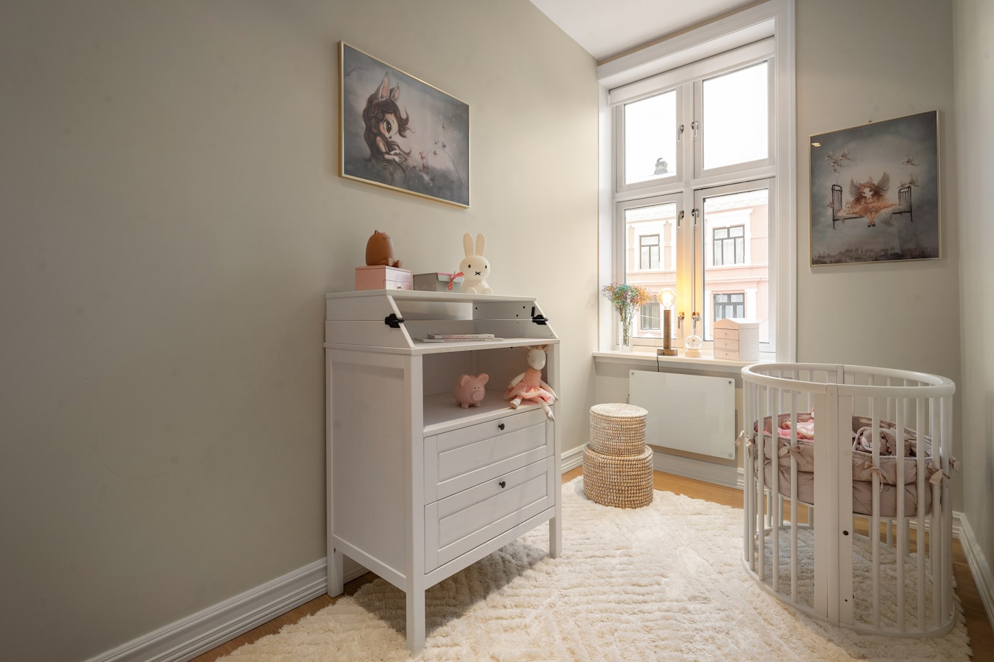 A nursery with a cot and storage