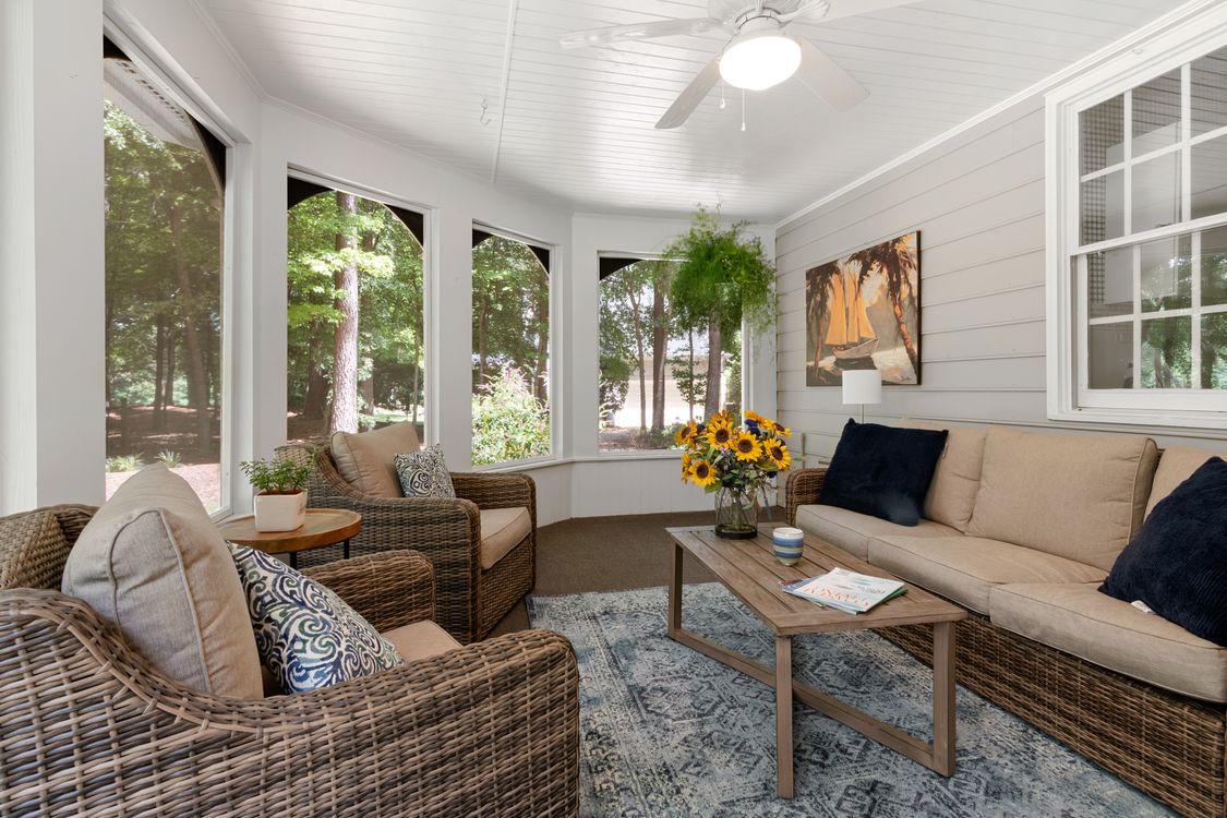 Bright furnished sunroom looking out onto a garden