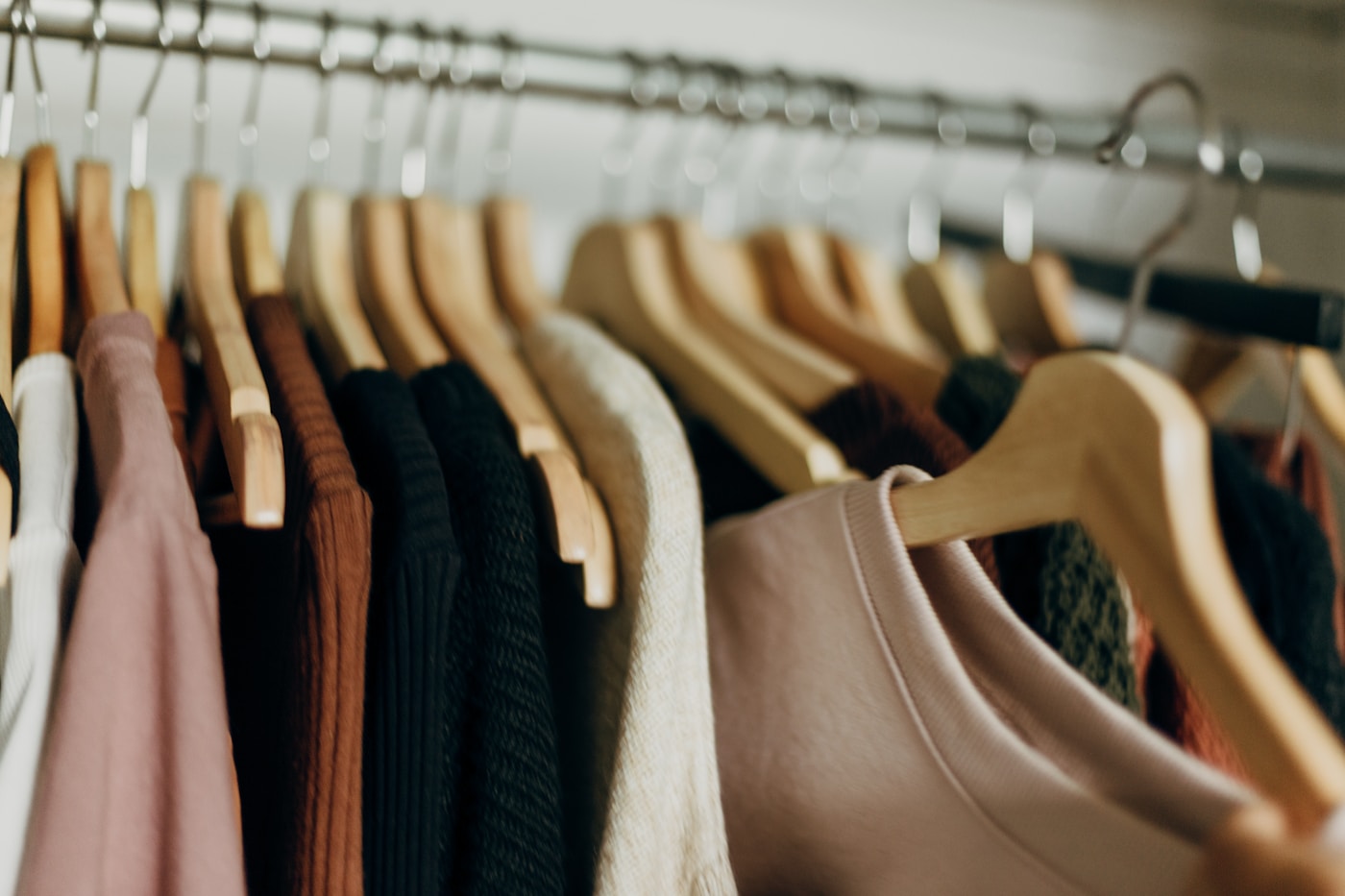 Autumn clothing arranged on a wardrobe rail